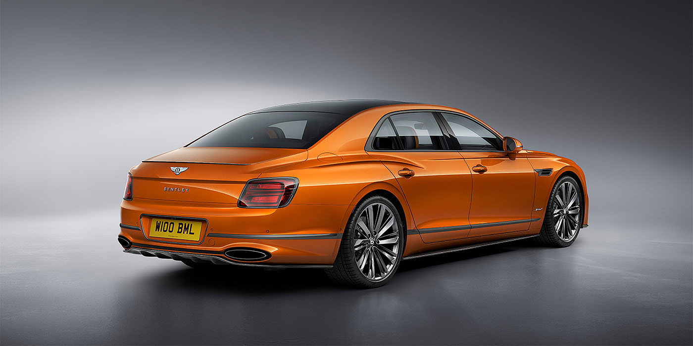 Bentley Cyprus Bentley Flying Spur Speed in Orange Flame colour rear view, featuring Bentley insignia and enhanced exhaust muffler.