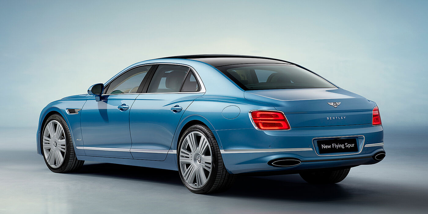 Bentley Cyprus New Bentley Flying Spur Azure sedan rear view in Light windsor blue by Mulliner paint with 22 inch Azure wheels and chrome exterior details
