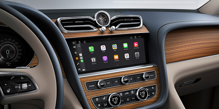 Bentley Cyprus Bentley Bentayga Extended Wheelbase Azure SUV front interior centre console with MMI screen showing apps, surrounded by Portland and Imperial Blue coloured hides
